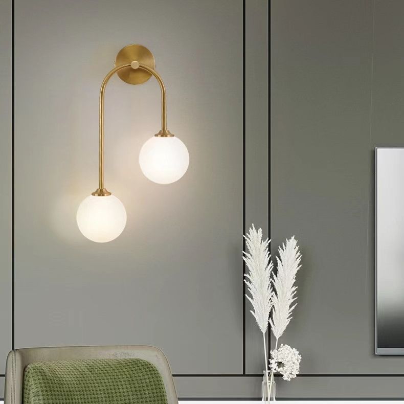 Vela Brass Arc Glass Globe Wall Light For Living Room